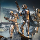 A group of space soldiers stands on a hill in front of an alien base.